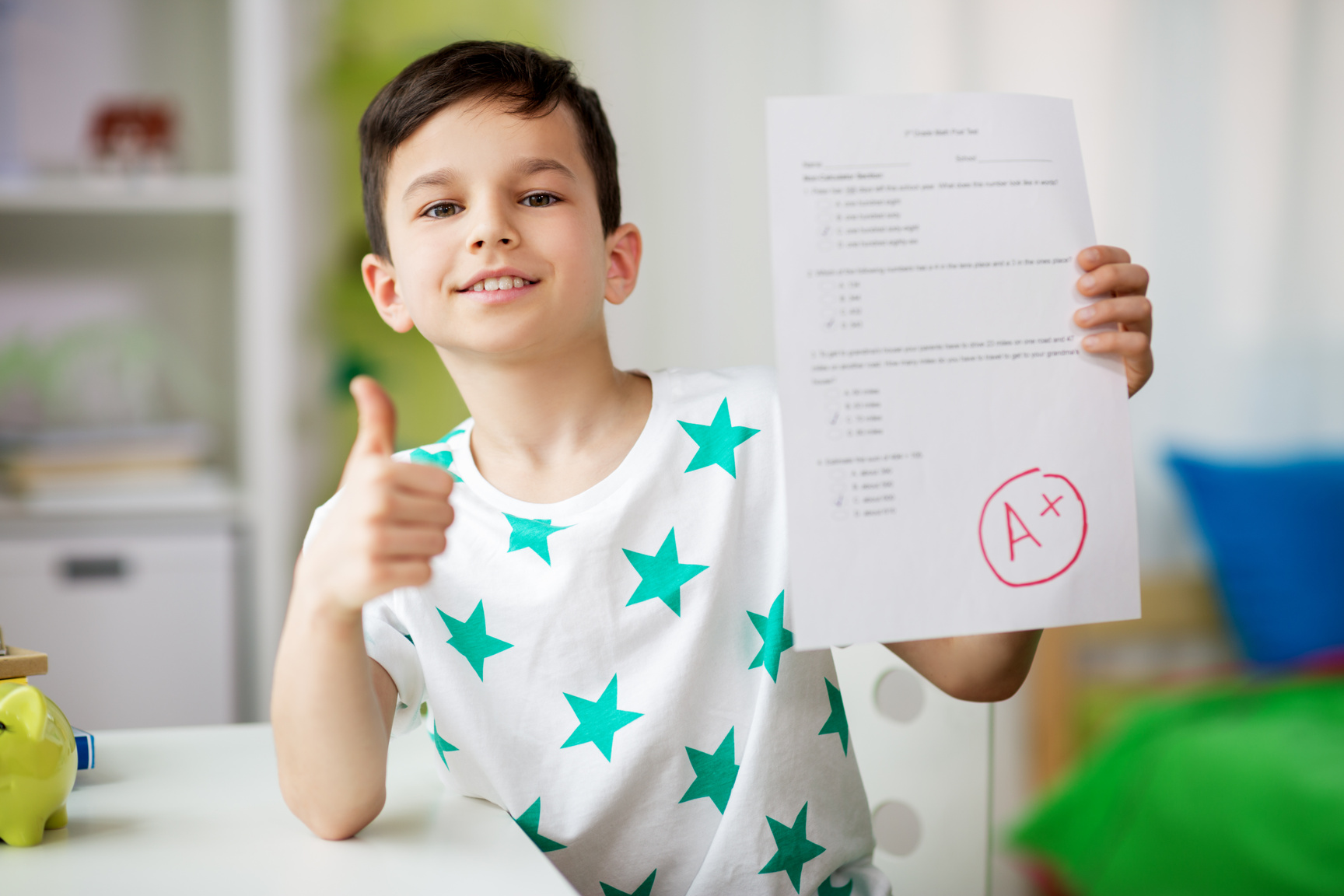 Happy Smiling Boy Holding School Test with a Grade
